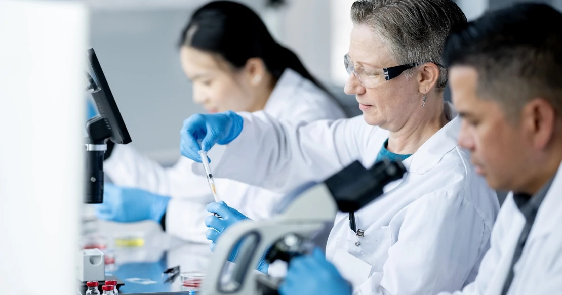 lab workers sampling looking at microscopes lab workers sampling looking at microscopes