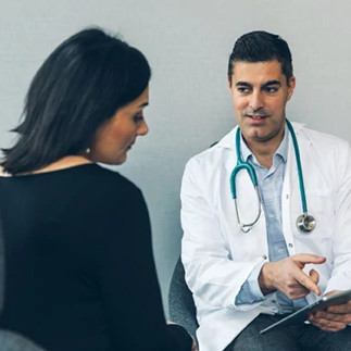 smiling-male-doctor-with-patient