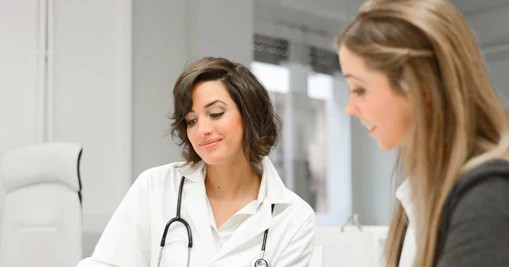 Two-female-doctors-reviewing-notes Two-female-doctors-reviewing-notes