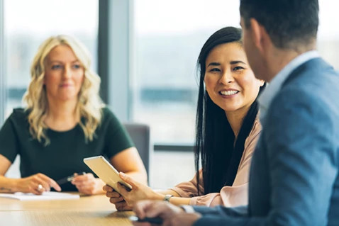 woman-smiling-during-a-meeting woman-smiling-during-a-meeting